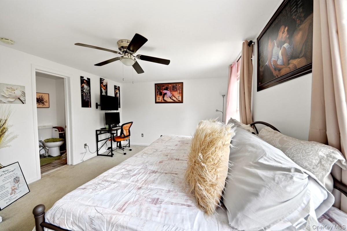 708 Mallard Way Peekskill, NY 10566 - Photo 22 of 29 a bedroom with a bed and a flat screen tv