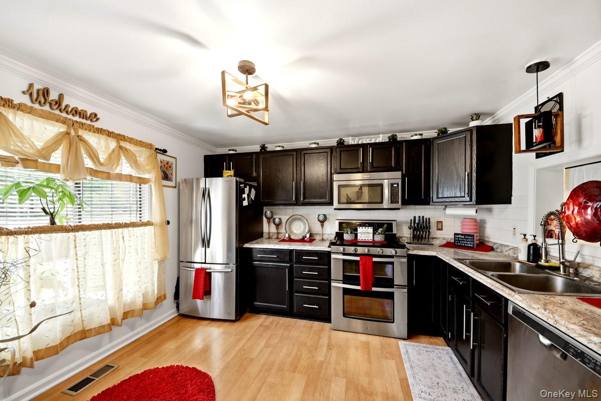708 Mallard Way Peekskill, NY 10566 - Photo 3 of 29 a kitchen with cabinets a sink and a stove