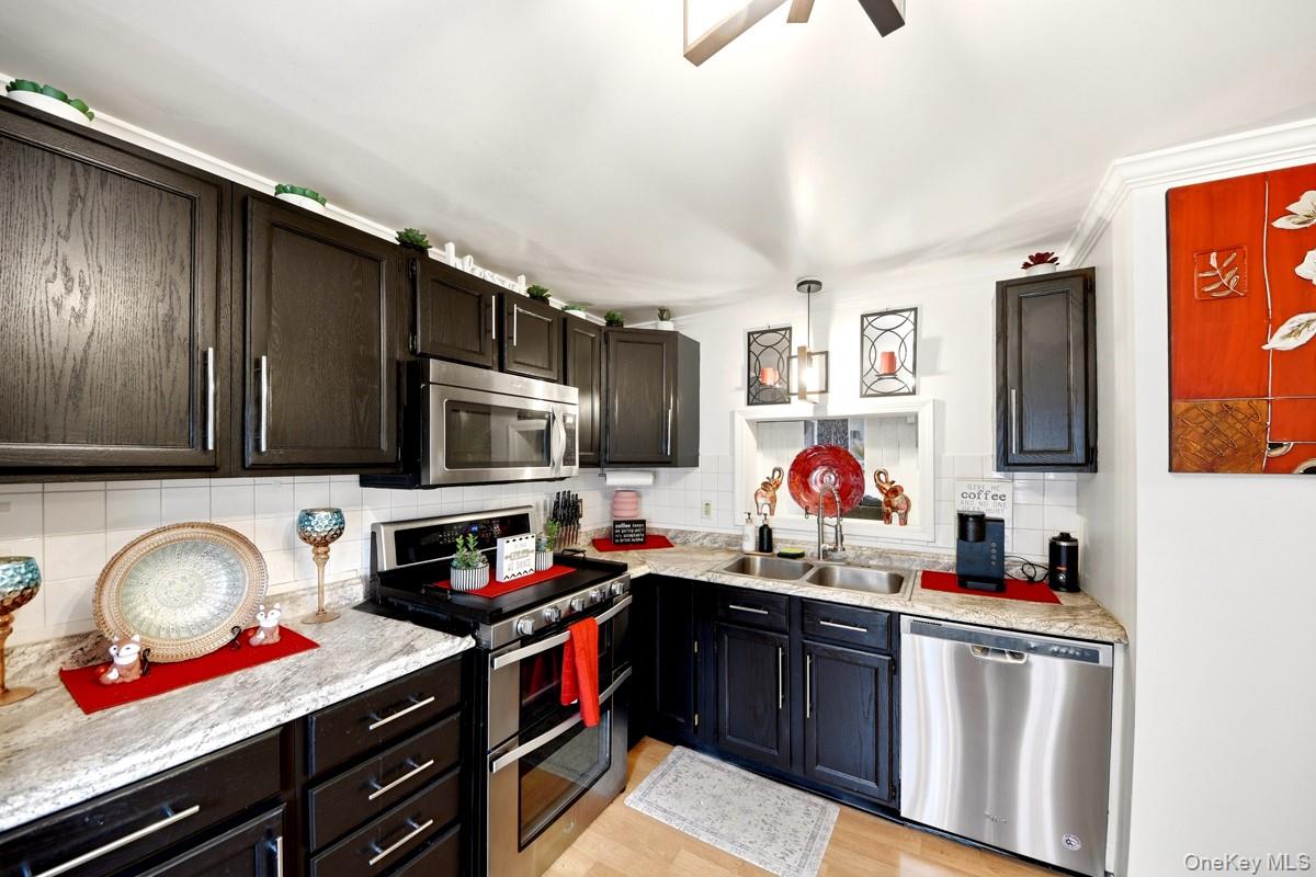 708 Mallard Way Peekskill, NY 10566 - Photo 4 of 29 a kitchen with stainless steel appliances granite countertop a stove and cabinets