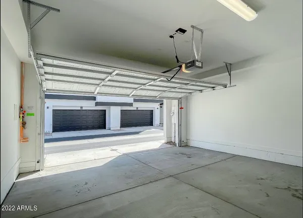 an empty room with sliding door and chandelier fan