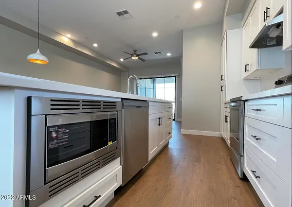 a kitchen with a stove sink and cabinets