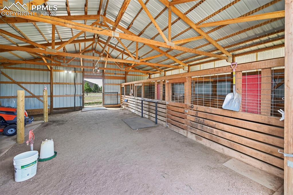14775 Judge Orr Road Peyton, CO 80831 - Photo 40 of 49 Interior Hitching Post/ 3 stalls with mats and feeders/Hay Storage or room for additional stalls