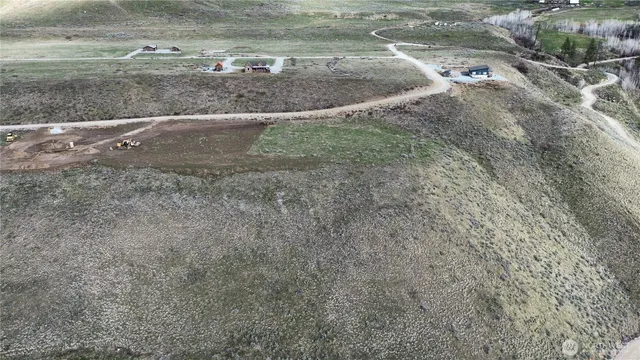 a view of a dry yard with wooden fence