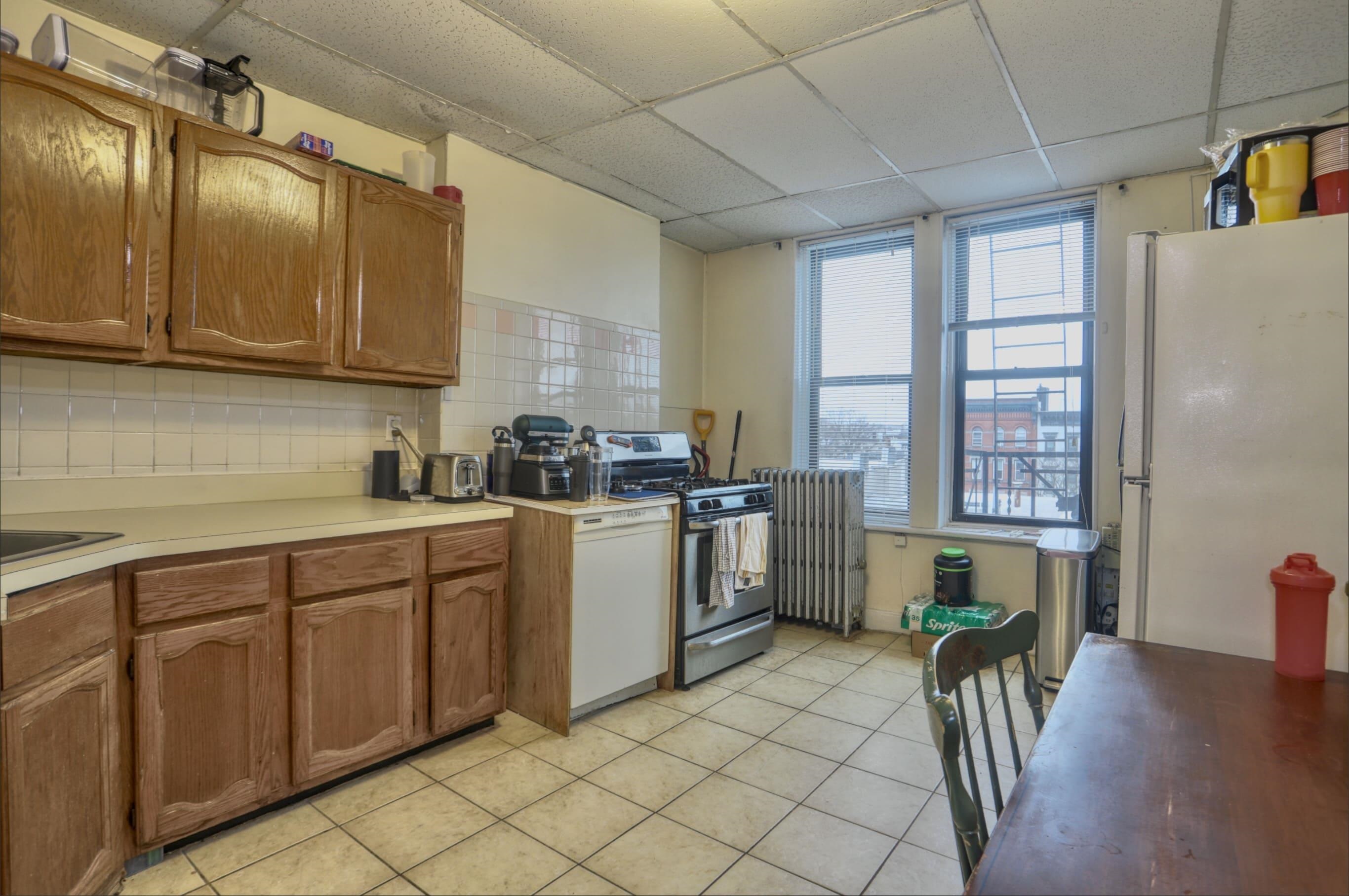a kitchen with a sink cabinets and window
