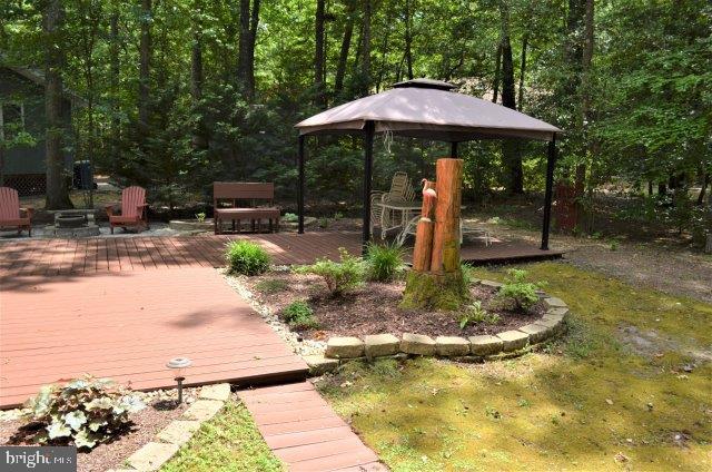 77 Sandyhook Road Ocean Pines, MD 21811 - Photo 2 of 31 a backyard of a house with barbeque oven
