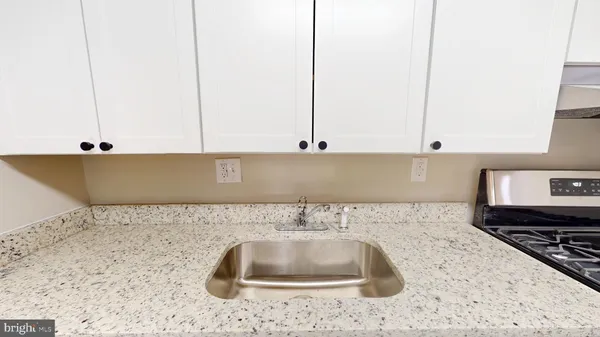a kitchen with a sink and cabinets