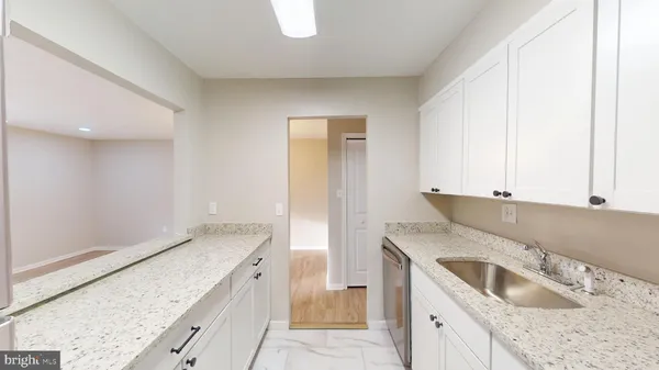 a kitchen with granite countertop a sink and a stove
