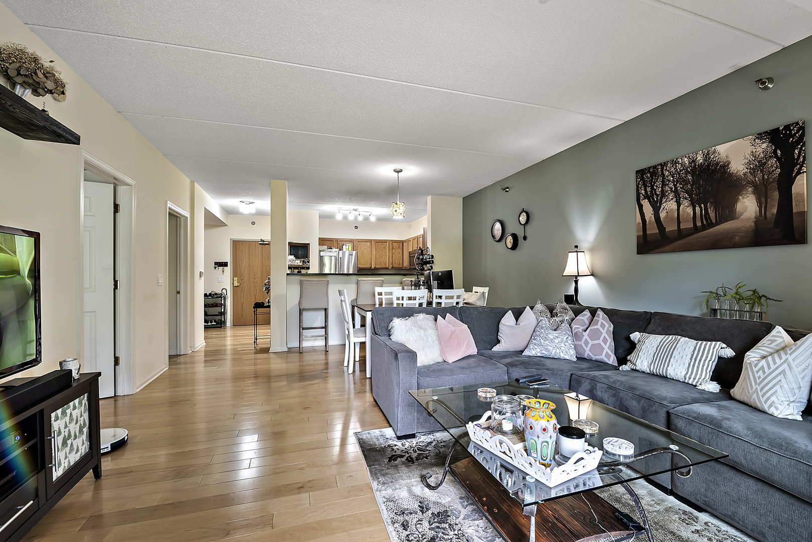 440 West Mahogany Court, Unit 208 Palatine, IL 60067 - Photo 7 of 16 a living room with furniture and wooden floor