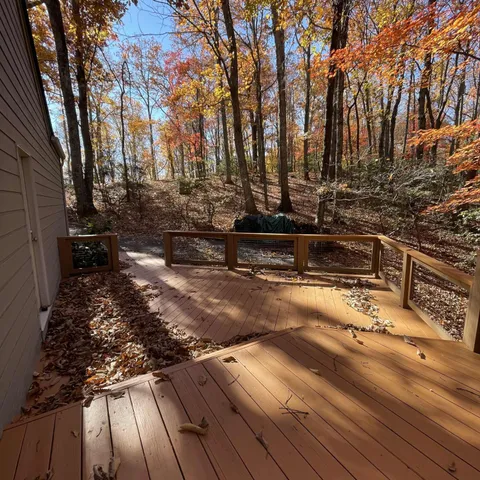 a view of a yard with wooden fence