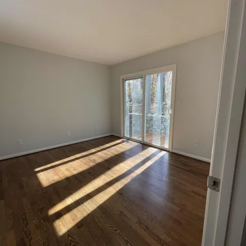 a view of room with window and wooden floor