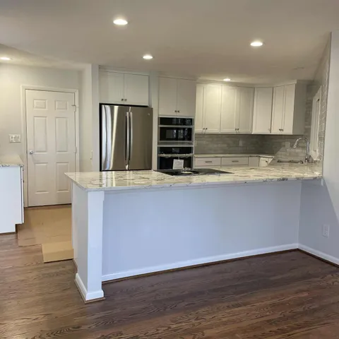 a view of kitchen with wooden floor