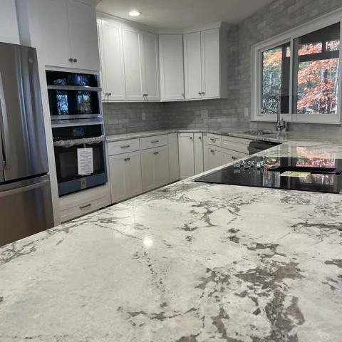 a kitchen with stainless steel appliances a refrigerator sink and stove