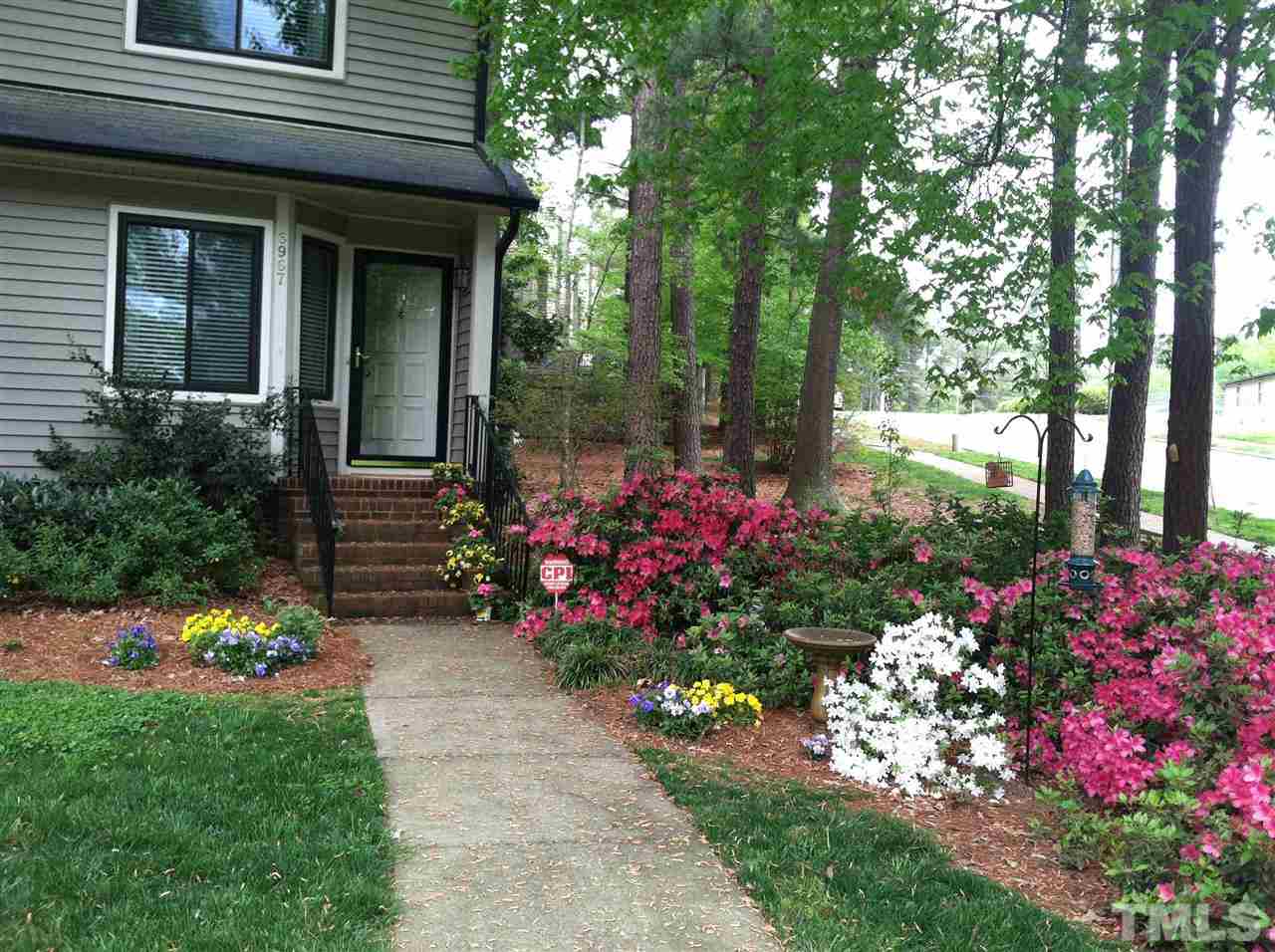 6967 Staghorn Lane Raleigh, NC 27615 - Photo 1 of 11 a view of a potted plant sitting in front of a house