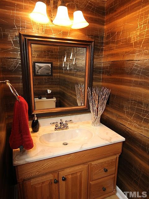 6967 Staghorn Lane Raleigh, NC 27615 - Photo 4 of 11 a bathroom with a sink and a mirror