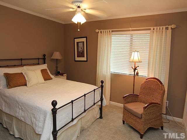 6967 Staghorn Lane Raleigh, NC 27615 - Photo 6 of 11 a bedroom with a bed couch and a window