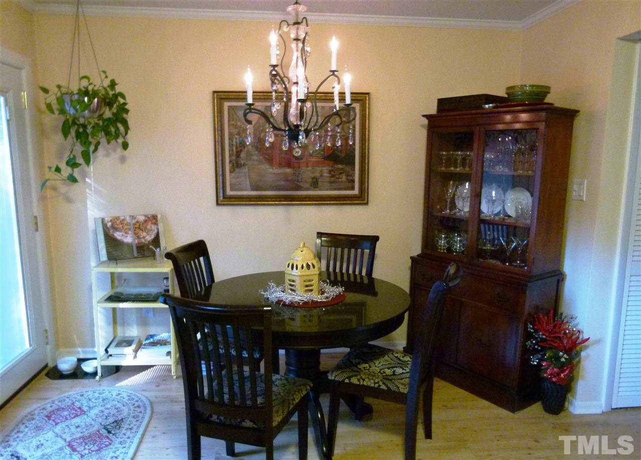 6967 Staghorn Lane Raleigh, NC 27615 - Photo 8 of 11 a view of a dining room with furniture and wooden floor
