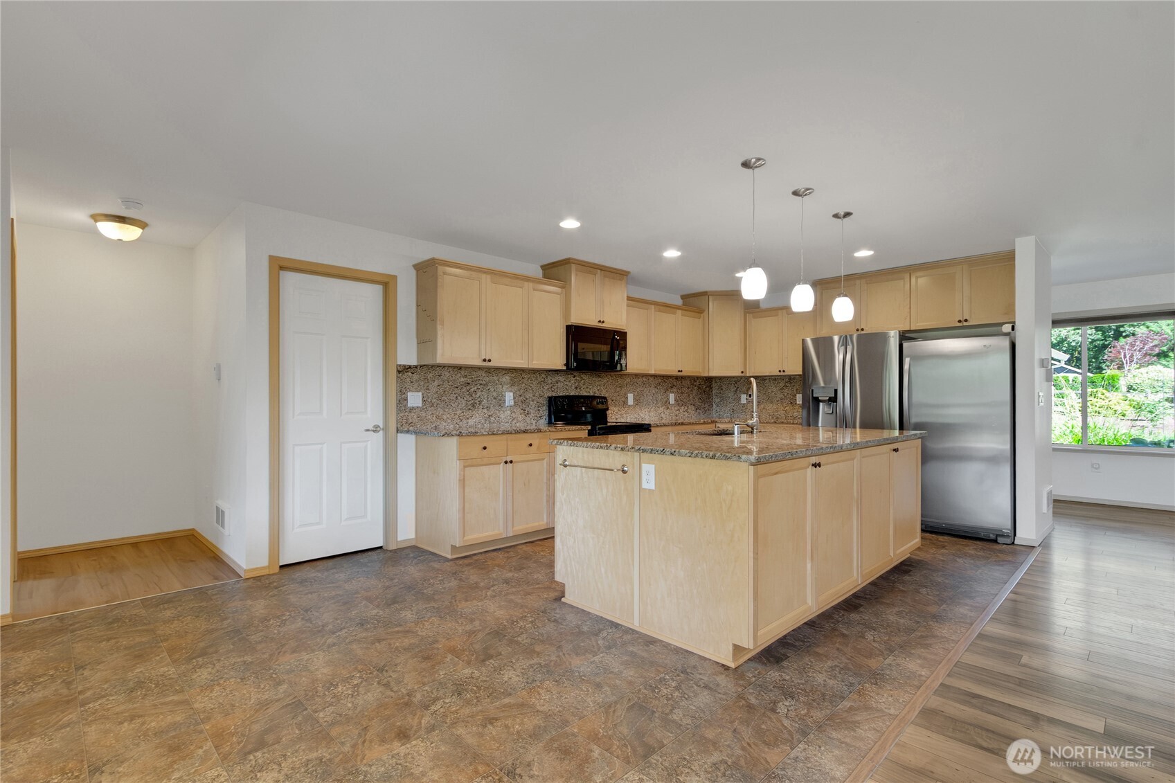 1450 Southeast Spruce Road Port Orchard, WA 98367 - Photo 15 of 39 a large kitchen with stainless steel appliances granite countertop a stove a sink a refrigerator and white cabinets with wooden floor