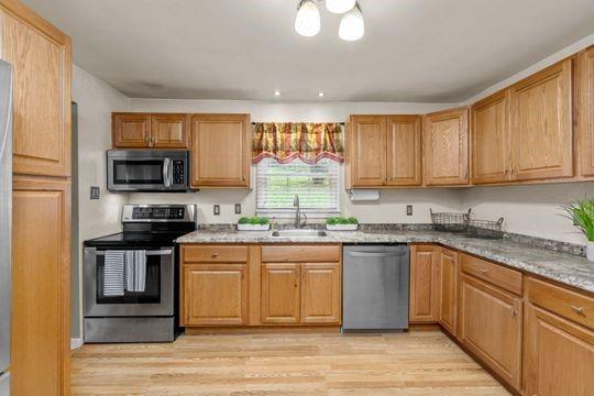 2050 Township Road Monroeville, PA 15146 - Photo 11 of 25 a kitchen with stainless steel appliances granite countertop a stove top oven a sink dishwasher and a microwave oven on the blue kitchen countertops
