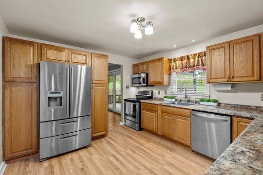 2050 Township Road Monroeville, PA 15146 - Photo 10 of 25 a kitchen with stainless steel appliances granite countertop a refrigerator a sink dishwasher a stove with wooden floor and cabinets