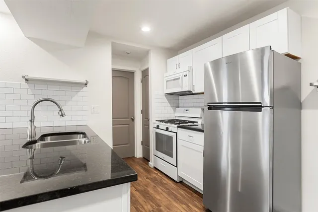 a kitchen with a refrigerator and a sink