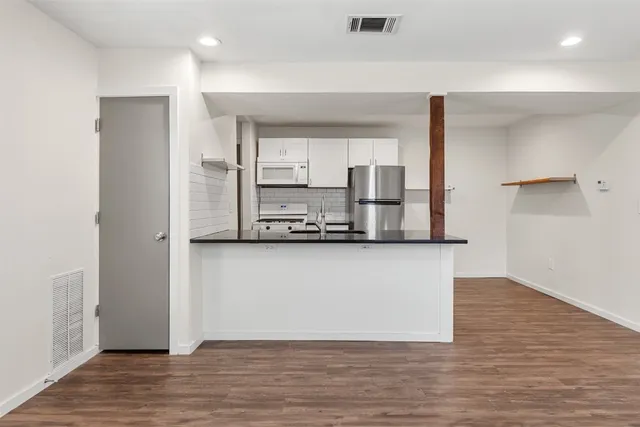 a view of kitchen with wooden floor