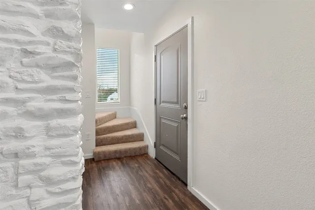 a view of a livingroom with furniture and an empty room