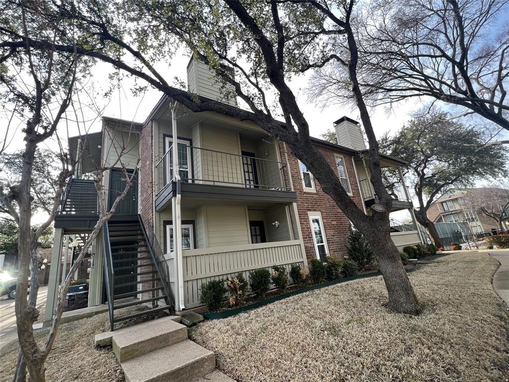 a large tree in the front of a house