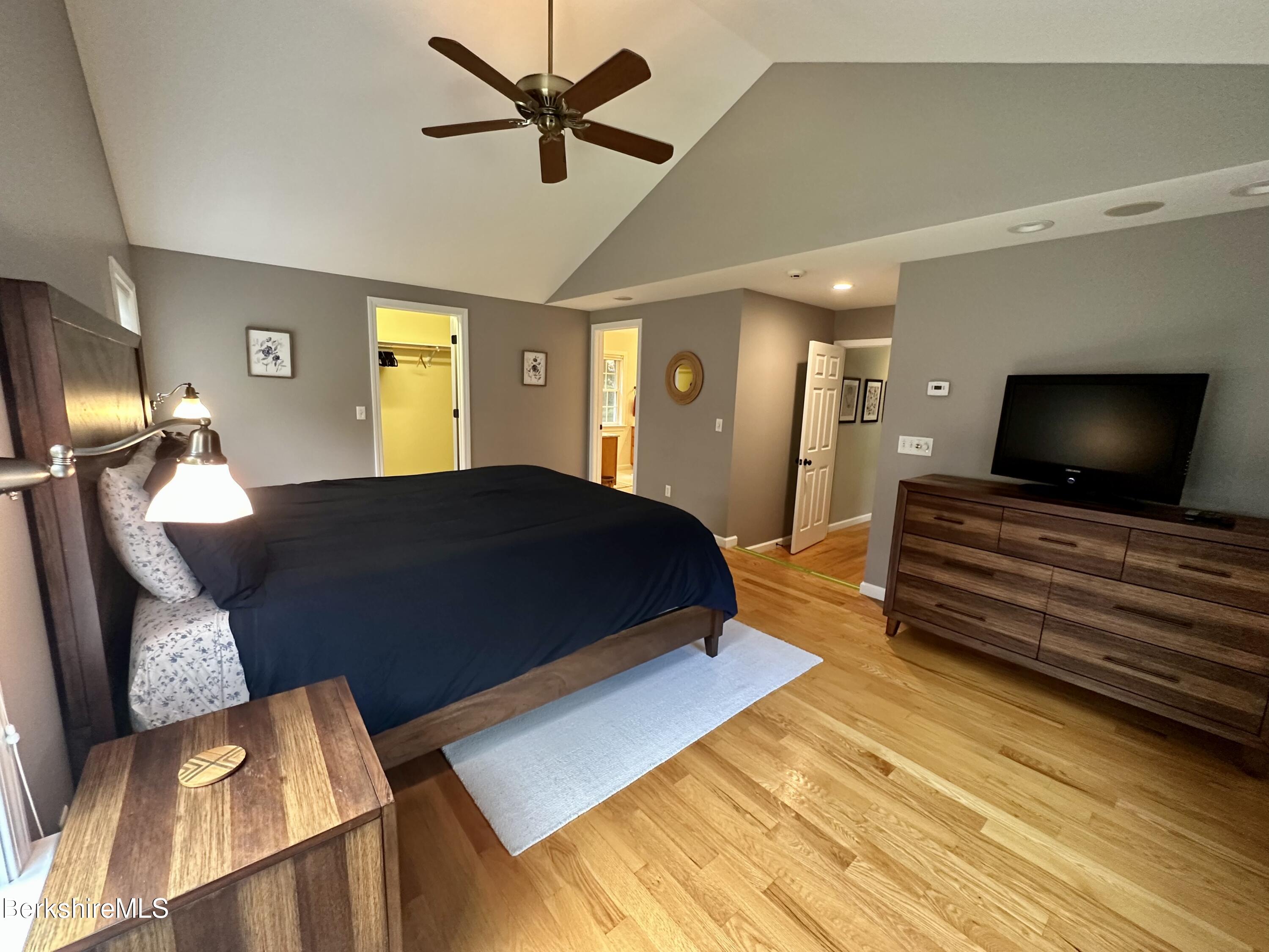 199 Old Post Road Richmond, MA 01201 - Photo 19 of 40 a bedroom with a bed and a flat screen tv