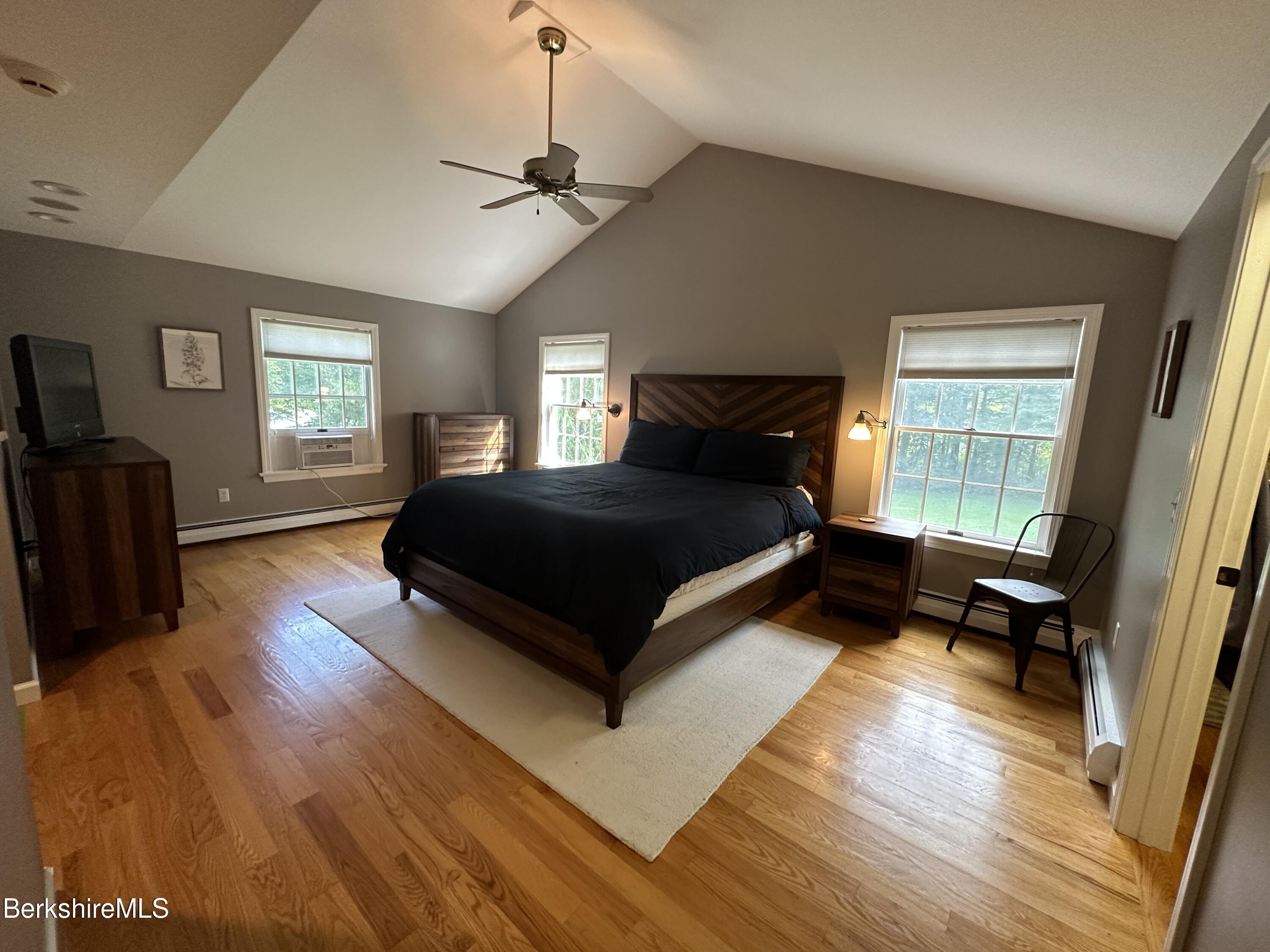 199 Old Post Road Richmond, MA 01201 - Photo 20 of 40 a bedroom with a bed and wooden floor