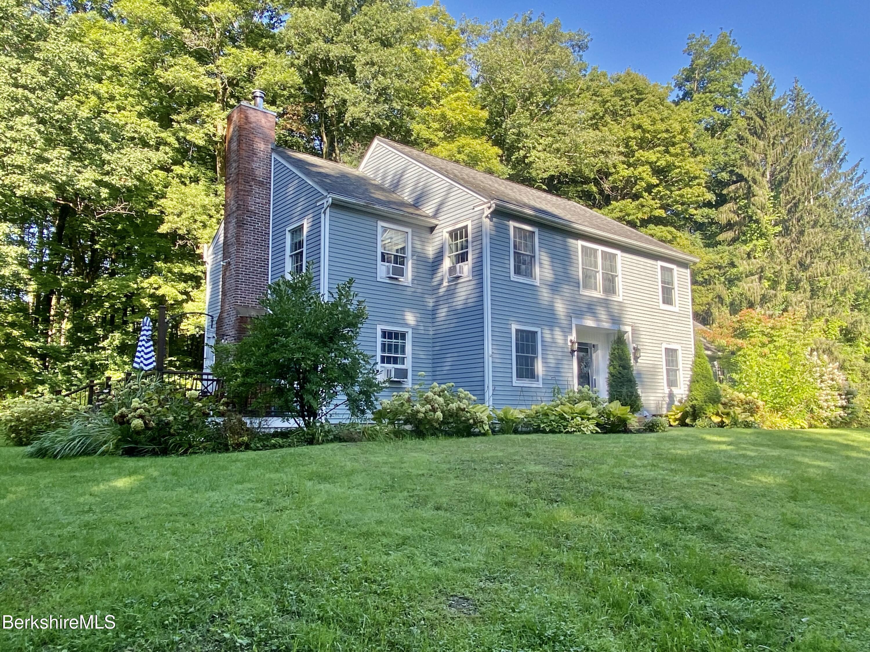 199 Old Post Road Richmond, MA 01201 - Photo 2 of 40 a brick building sitting in front of a big yard with potted plants and large trees