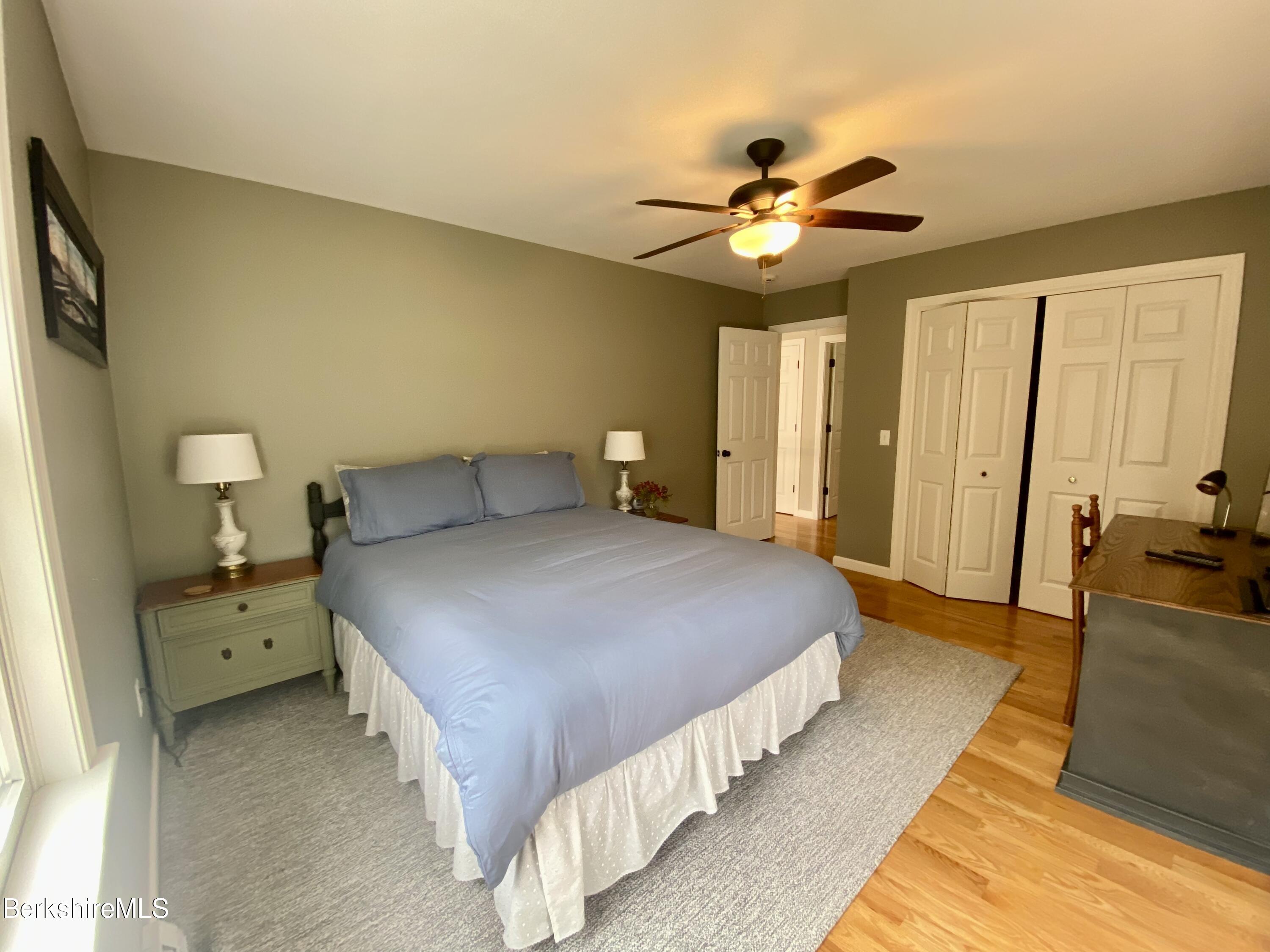 199 Old Post Road Richmond, MA 01201 - Photo 26 of 40 a bedroom with a bed and a chandelier