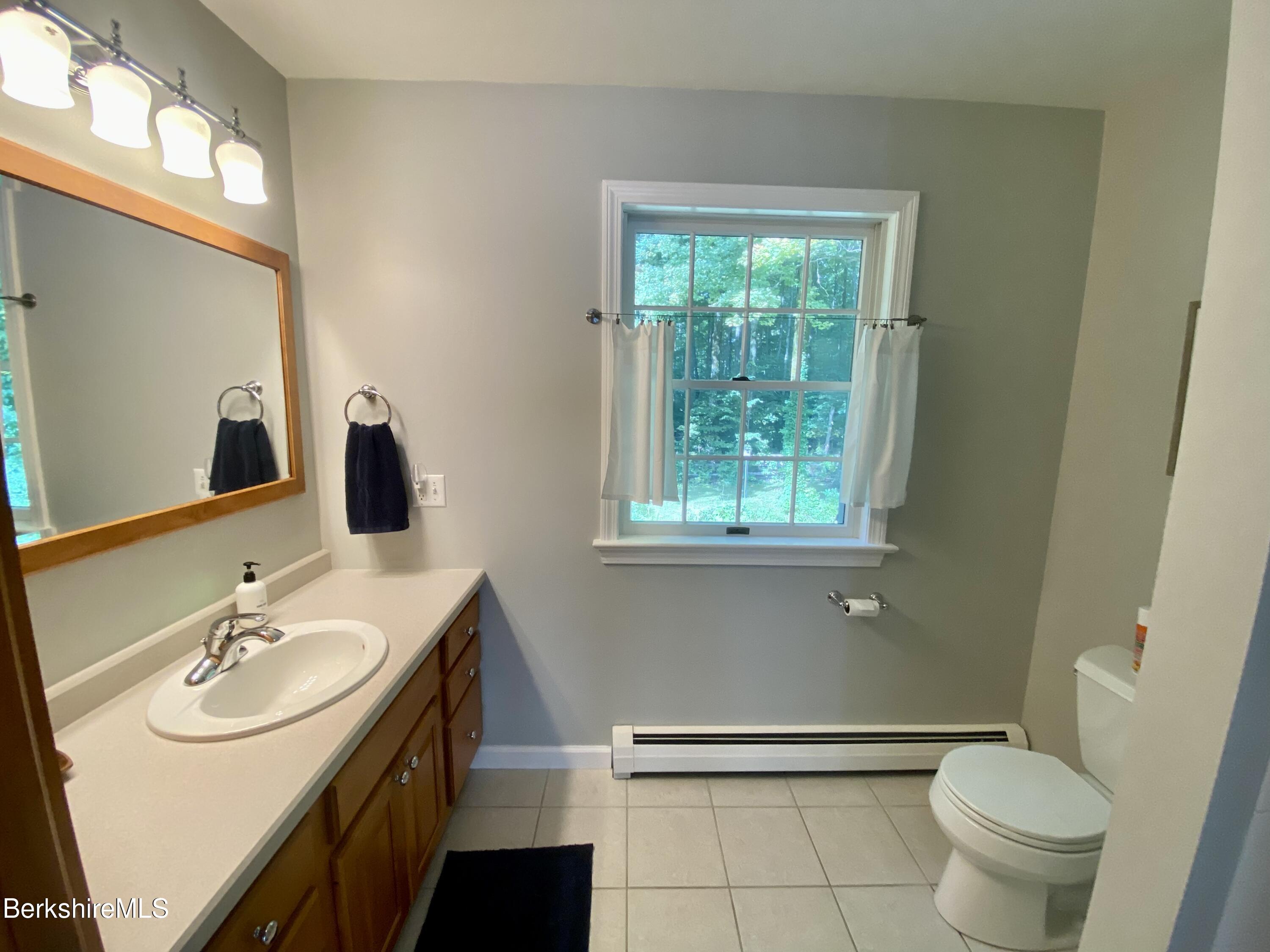 199 Old Post Road Richmond, MA 01201 - Photo 27 of 40 a bathroom with a sink toilet and a mirror