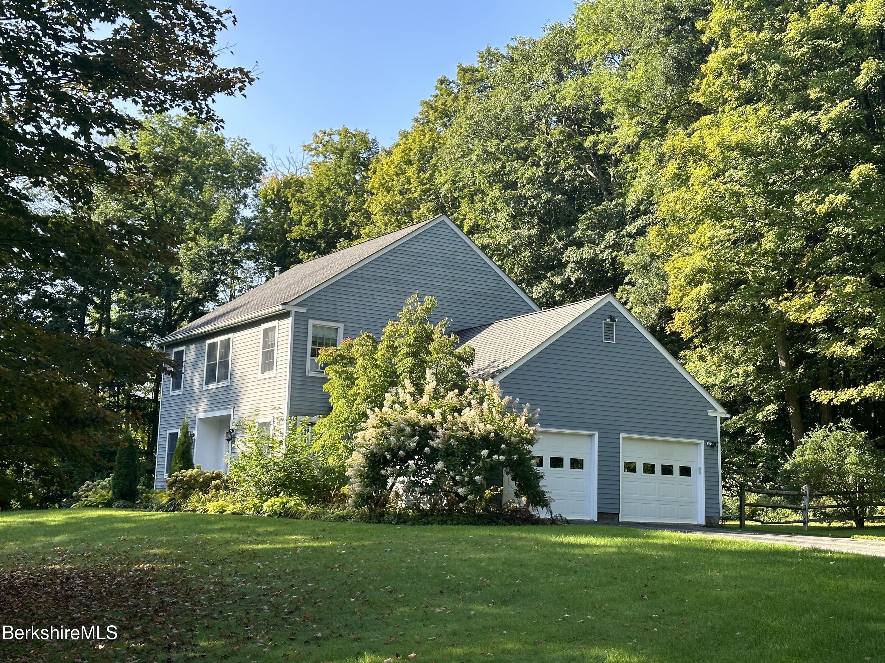 199 Old Post Road Richmond, MA 01201 - Photo 3 of 40 a front view of a house with a garden and trees