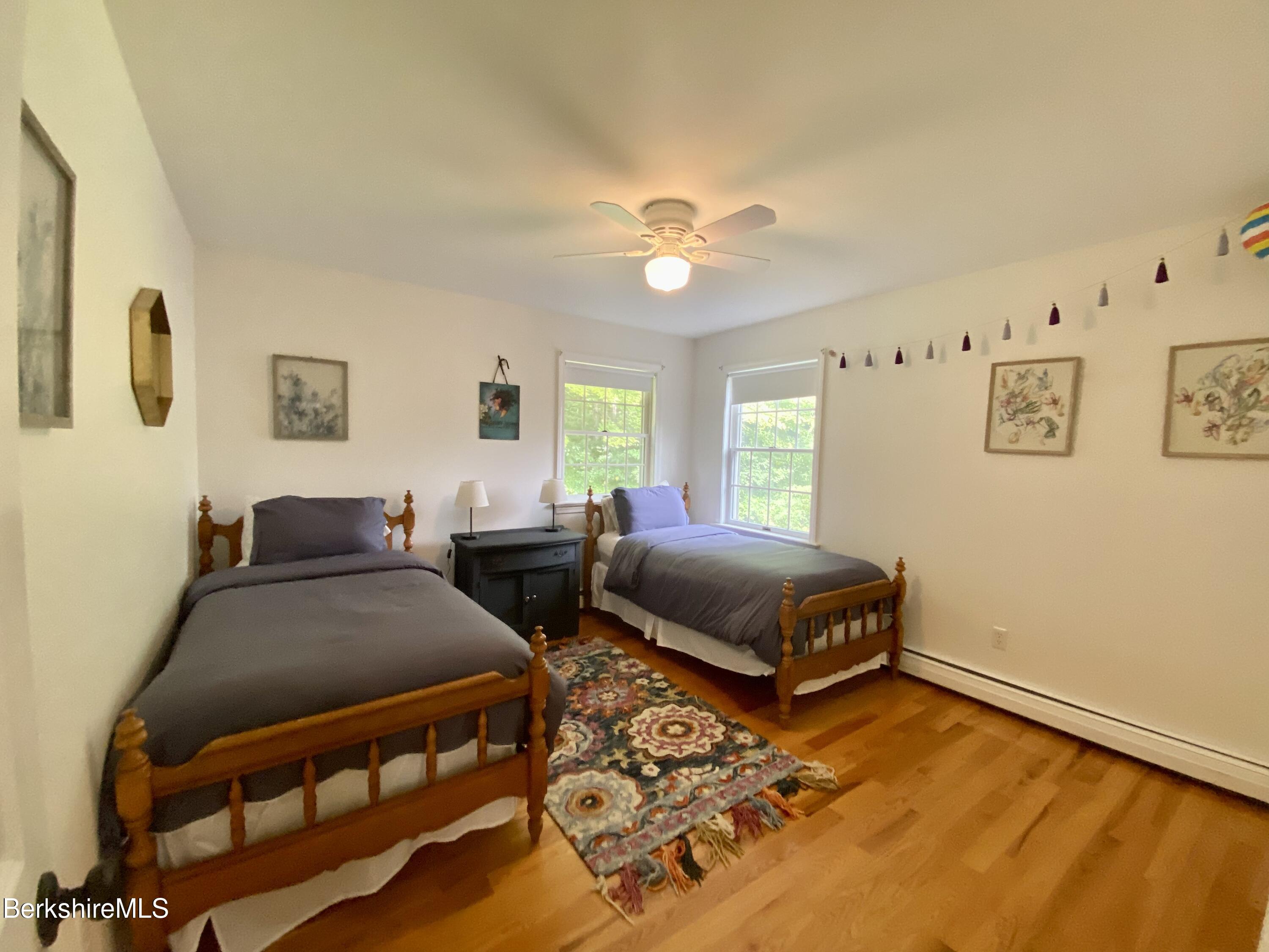 199 Old Post Road Richmond, MA 01201 - Photo 31 of 40 a bedroom with a bed and wooden floor