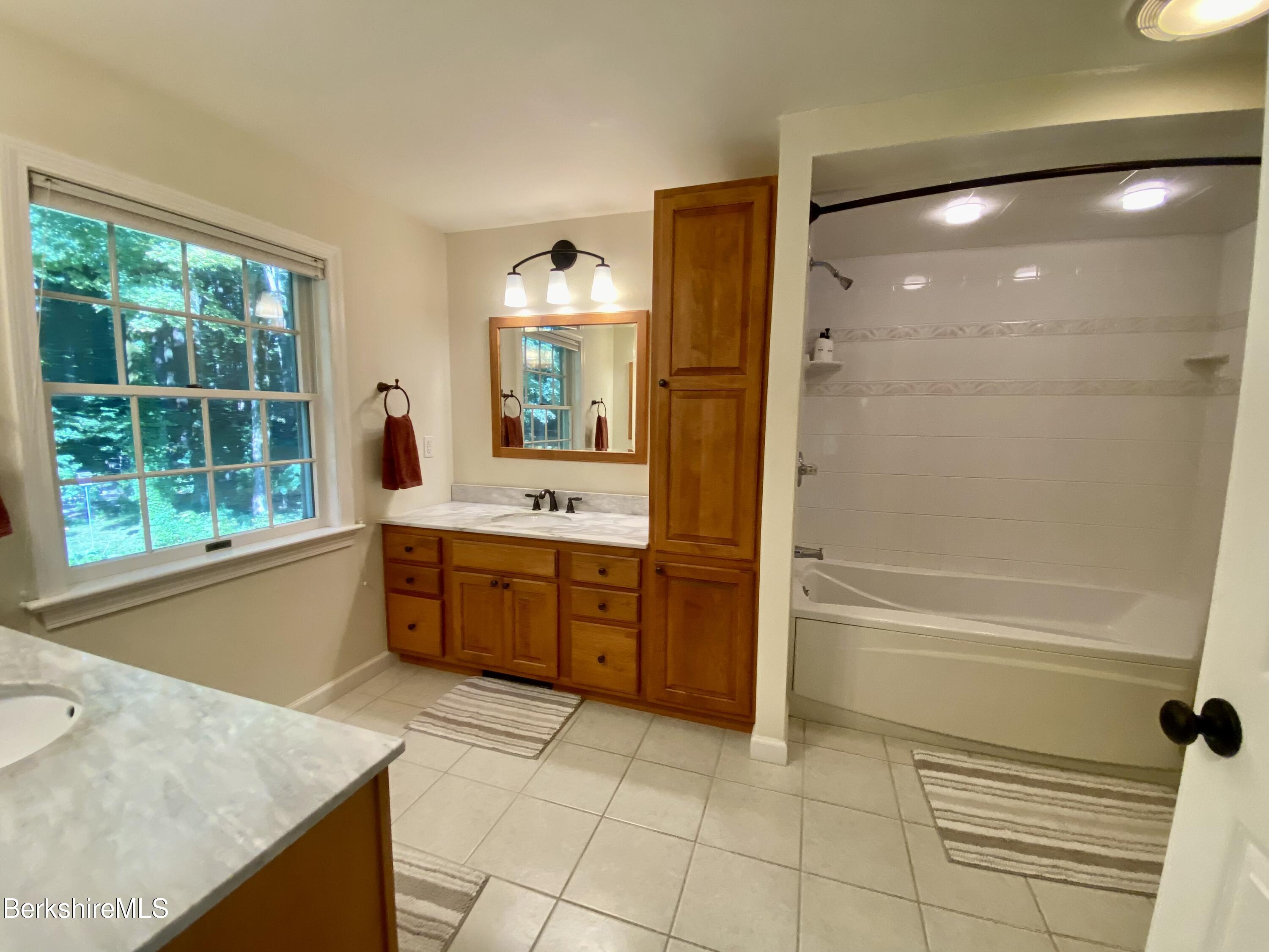 199 Old Post Road Richmond, MA 01201 - Photo 32 of 40 a large bathroom with a tub sink shower and mirror