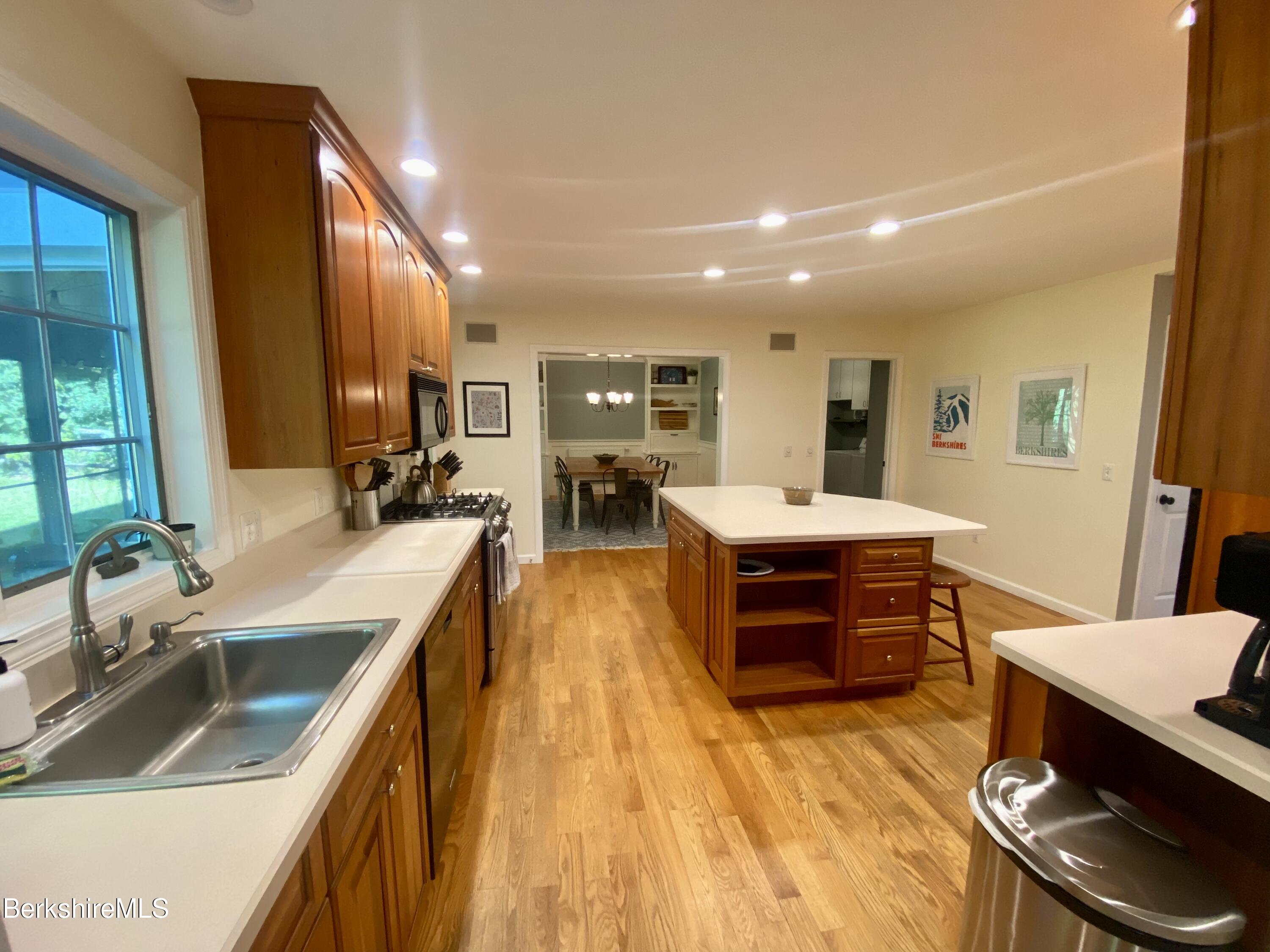 199 Old Post Road Richmond, MA 01201 - Photo 8 of 40 a large kitchen with stainless steel appliances kitchen island granite countertop a sink and cabinets