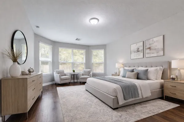 a bedroom with a large bed and a large window