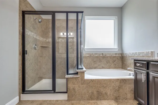 a bathroom with a bathtub and a shower