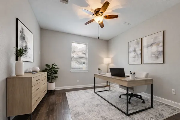 a bedroom with a bed and a lamp