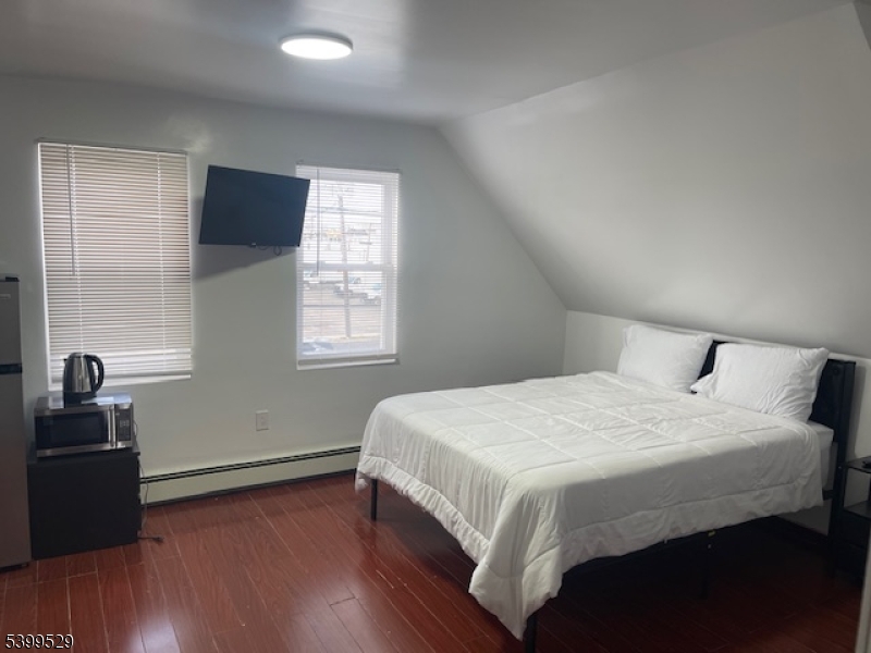 2420 East Edgar Road, Unit 3 Linden, NJ 07036 - Photo 2 of 6 a bedroom with a bed and a window