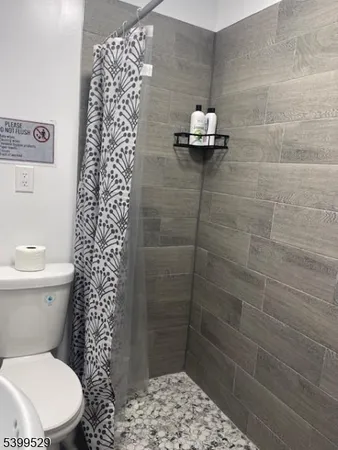 a bathroom with a toilet and shower