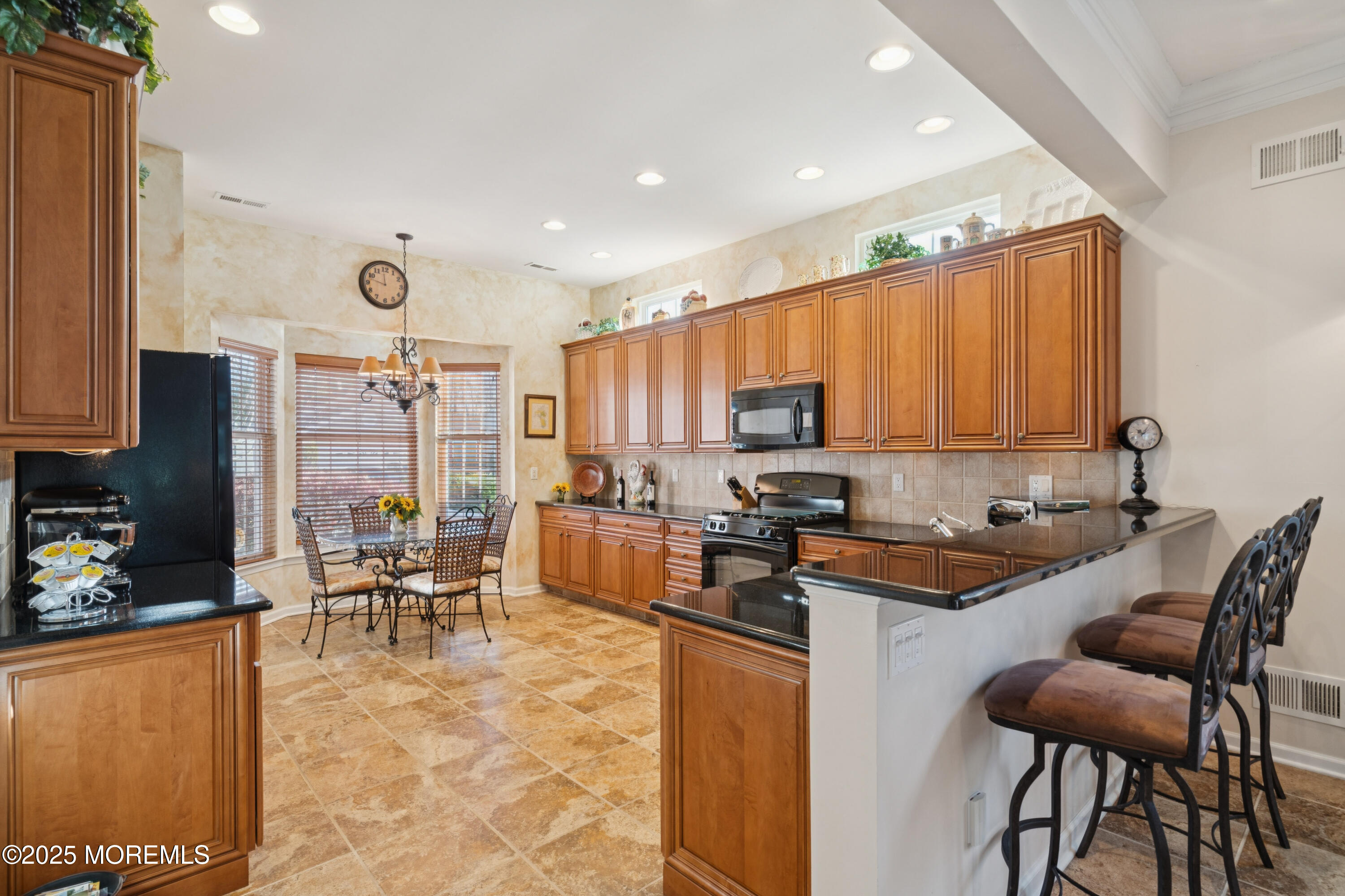 66 Crooked Stick Road Jackson, NJ 08527 - Photo 4 of 25 a kitchen with granite countertop a sink and chairs