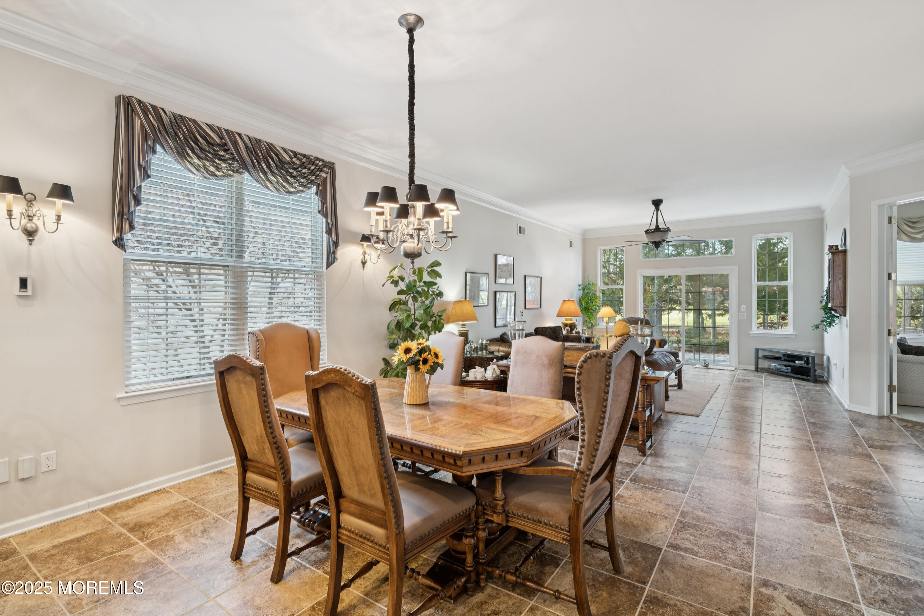 66 Crooked Stick Road Jackson, NJ 08527 - Photo 7 of 25 a view of a dining room and livingroom with furniture wooden floor a chandelier