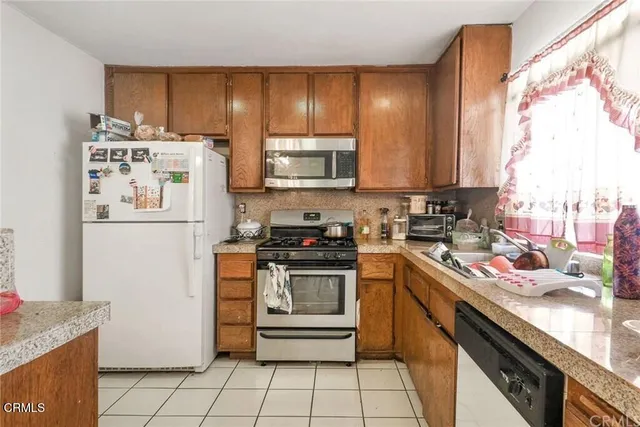 a kitchen with a stove a sink and a refrigerator
