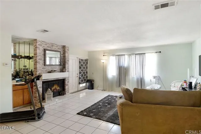 a bedroom with furniture a fireplace and a window