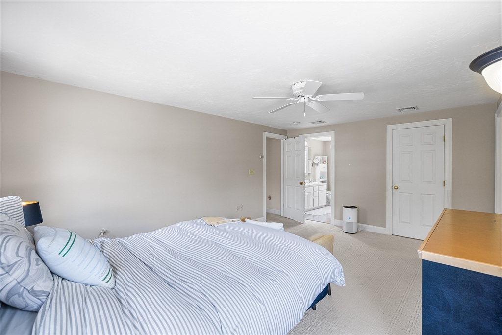 898 Main Street West Wareham, MA 02576 - Photo 19 of 36 a bedroom with a bed and a chandelier