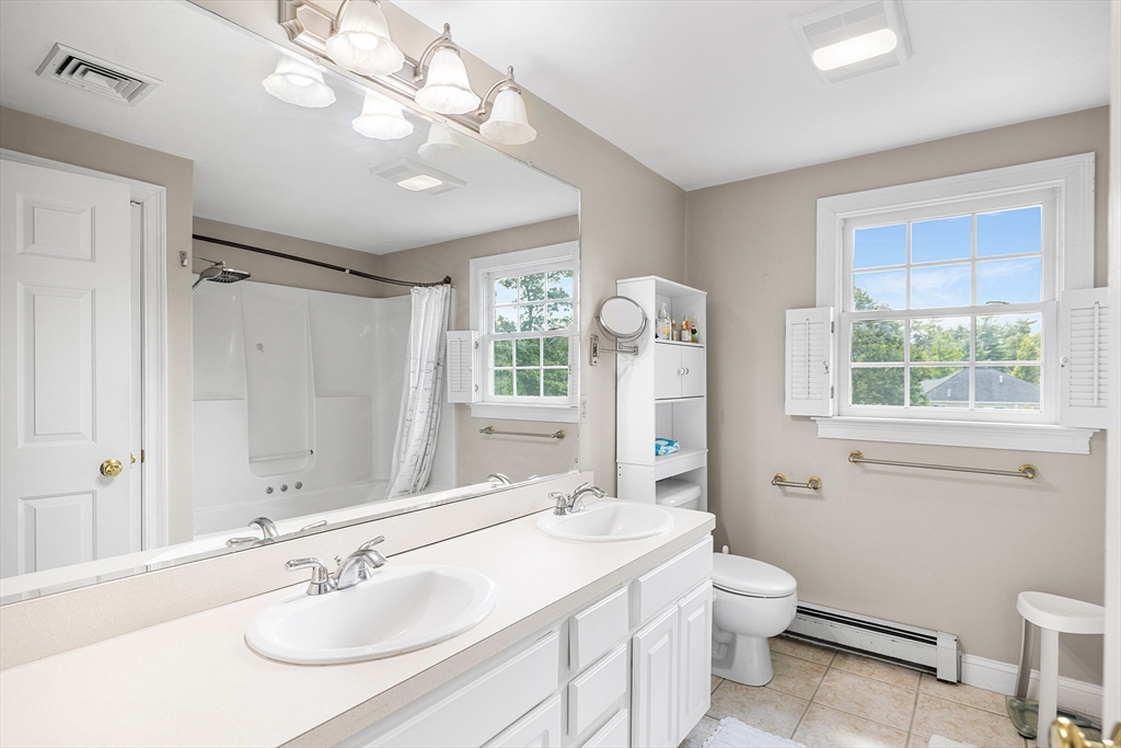 898 Main Street West Wareham, MA 02576 - Photo 20 of 36 a bathroom with a sink a toilet a mirror and shower