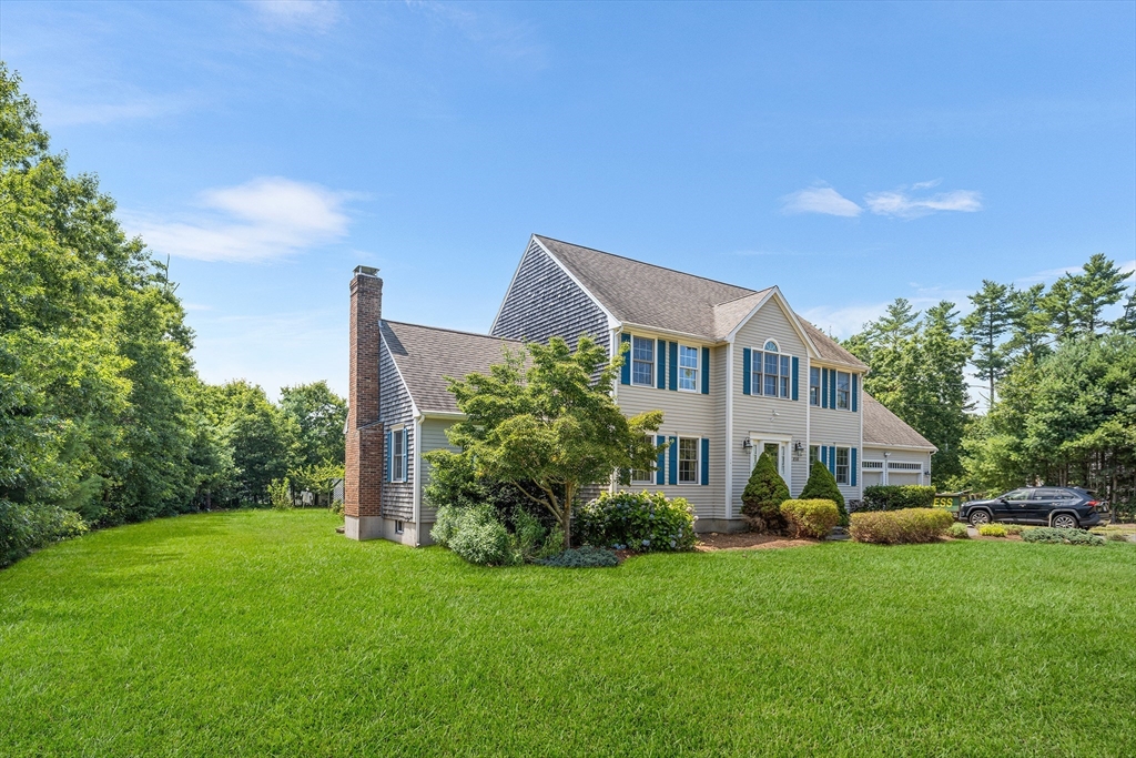 898 Main Street West Wareham, MA 02576 - Photo 2 of 36 a front view of a house with a yard and trees
