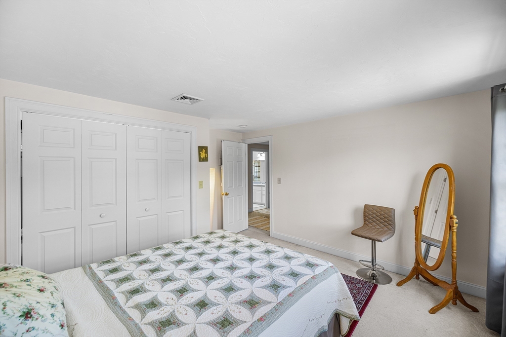 898 Main Street West Wareham, MA 02576 - Photo 23 of 36 a bedroom with a bed and a dresser