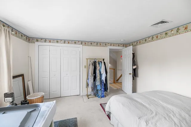 a bed room with a bed and a mirror